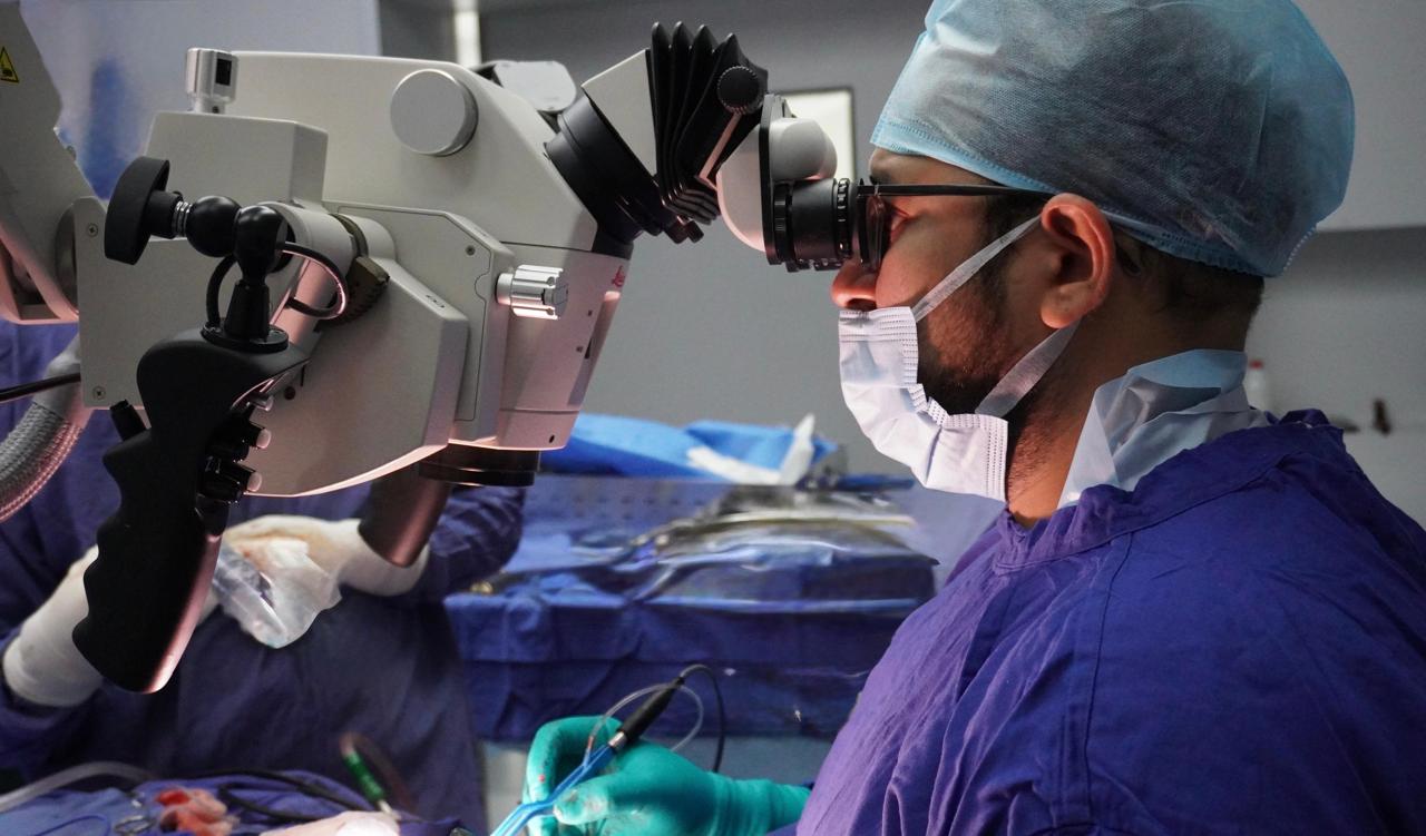 Dr. Pushkar Ranade operating with a surgical microscope
